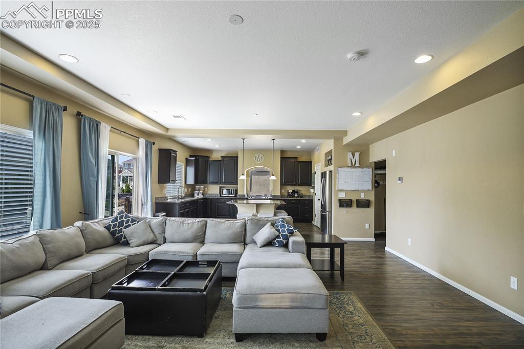 Image 8 of 38: Living room with dark wood-type flooring