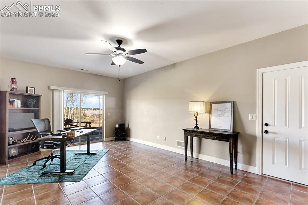 Image 24 of 31: This family room is big enough for a sectional, desk and even a treadmill..