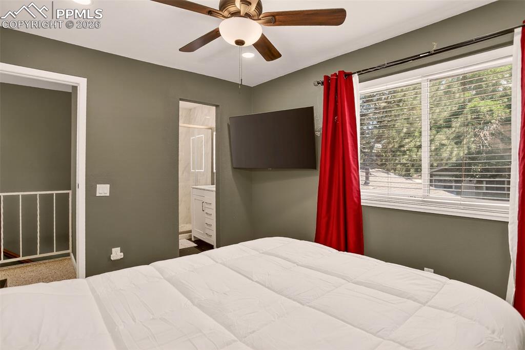 Image 12 of 22: "The primary bedroom features an en-suite bathroom, built-in shelving, fres