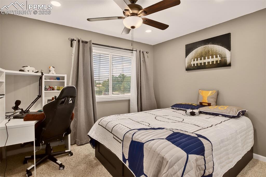 Image 13 of 22: Second bedroom features new paint, new carpet and ceiling fan for added com
