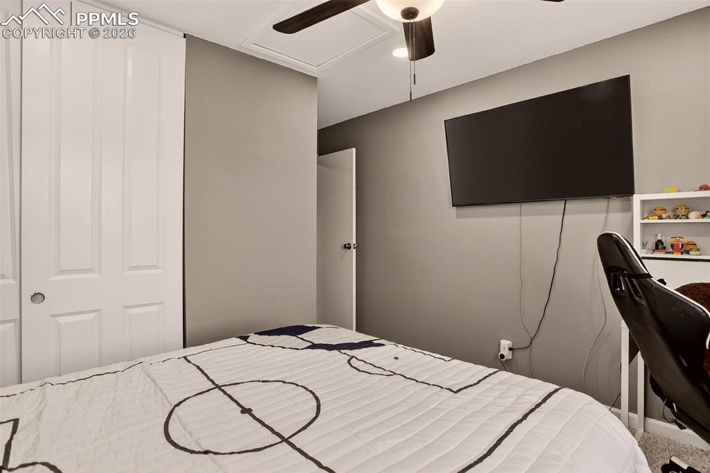 Image 14 of 22: Second bedroom features new paint, new carpet and ceiling fan for added com