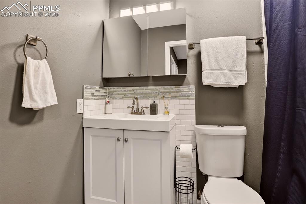 Image 15 of 22: The second bathroom includes an updated vanity and a tub.