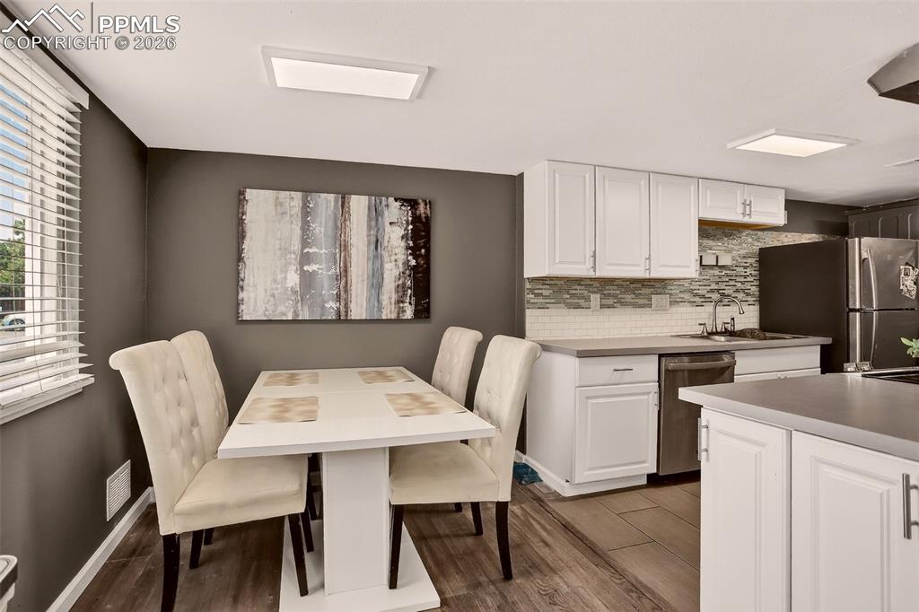 Image 6 of 22: "Bright and welcoming dining room with plenty of natural light, perfect for