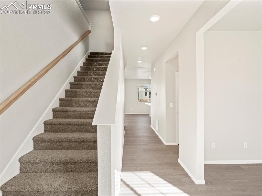 Image 14 of 26: Staircase featuring wood finished floors and recessed lighting