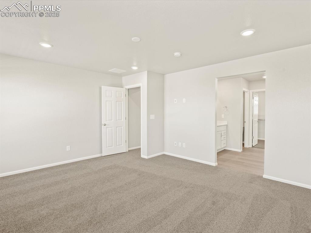 Image 21 of 26: Spare room featuring recessed lighting and light carpet