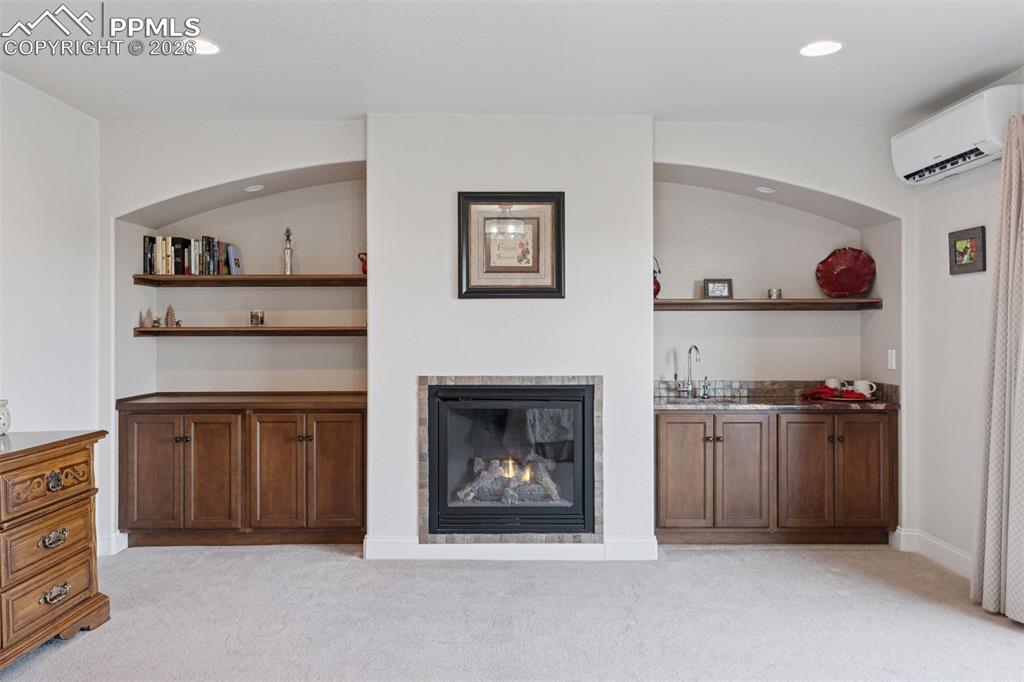 Image 22 of 50: Primary Suite w/Fireplace and built In Dry & Wet Bar Space w/insta hot wate