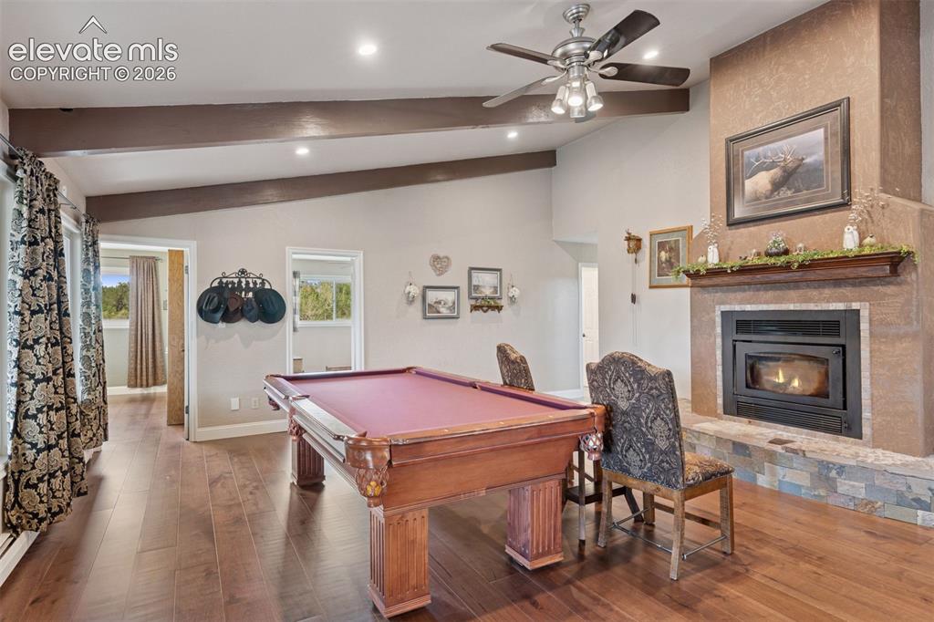 Image 26 of 50: Family Room with Limestone Fireplace, Hardwood Floors & Built-Ins