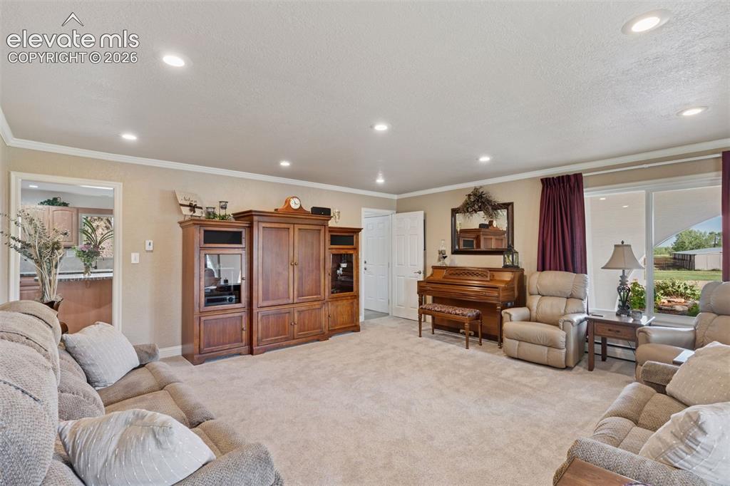 Image 33 of 50: Living Room with access to Kitchen, Mud Room and Powder Room.