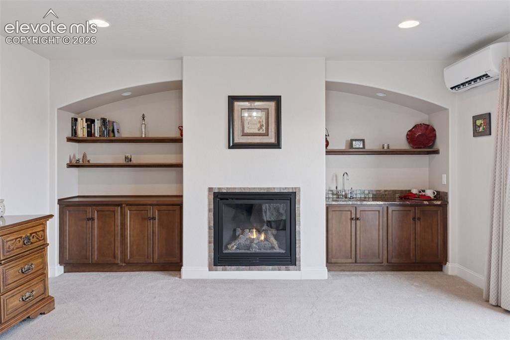 Image 37 of 50: Primary Suite with Fireplace, Built-In Wet/Dry Bar & Insta-Hot Water for mo