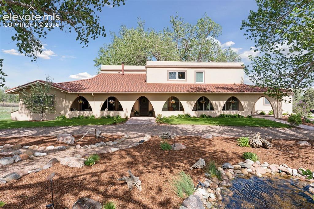 Image 4 of 50: Main Residence with Custom Landscaping & Water Feature