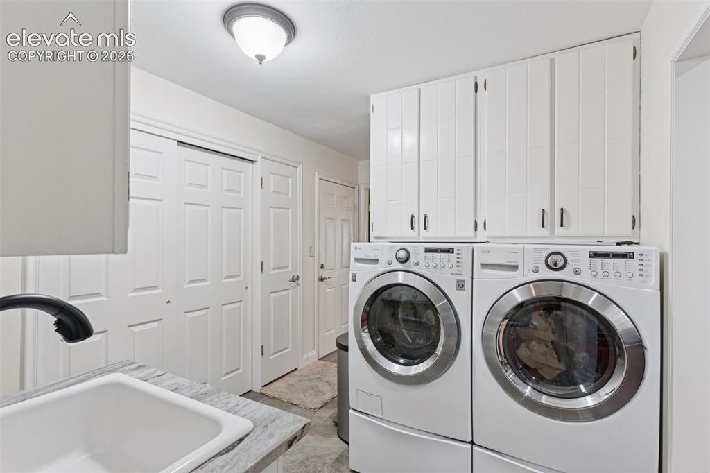 Image 44 of 50: Laundry Room conveniently located off of garage with storage space and farm