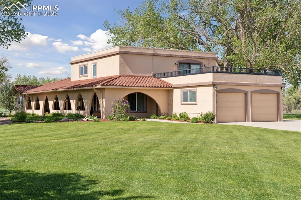 Image 6 of 50: View of front of home featuring stucco siding, an attached garage, a front 