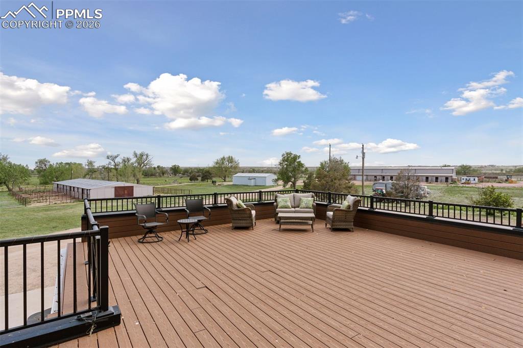 Image 8 of 50: Low maintenance deck off of Primary Suite overlooking facilities(not pictur
