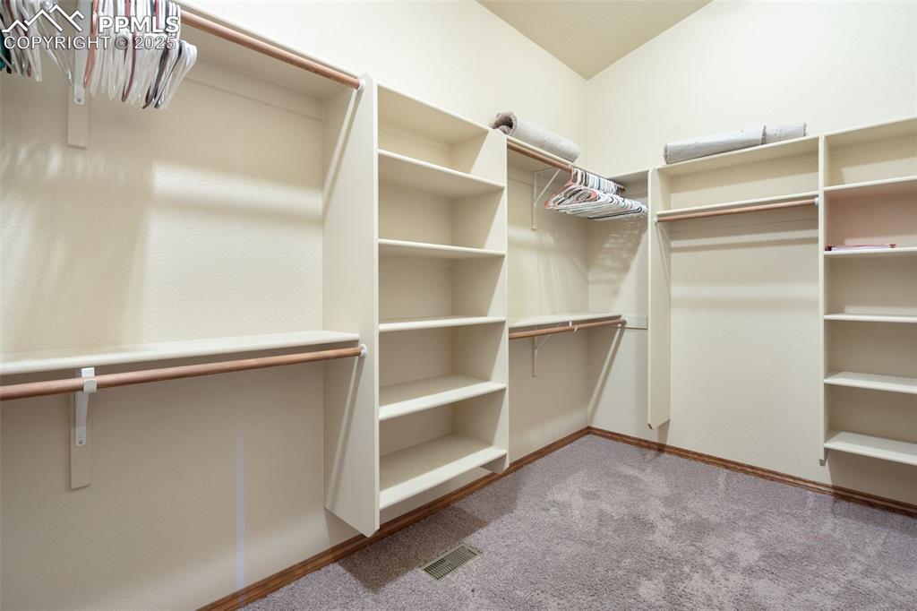 Image 22 of 50: Primary walk-in closet.