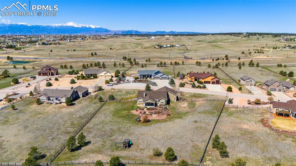 Image 49 of 50: Rear of acreage is fenced with split rail.