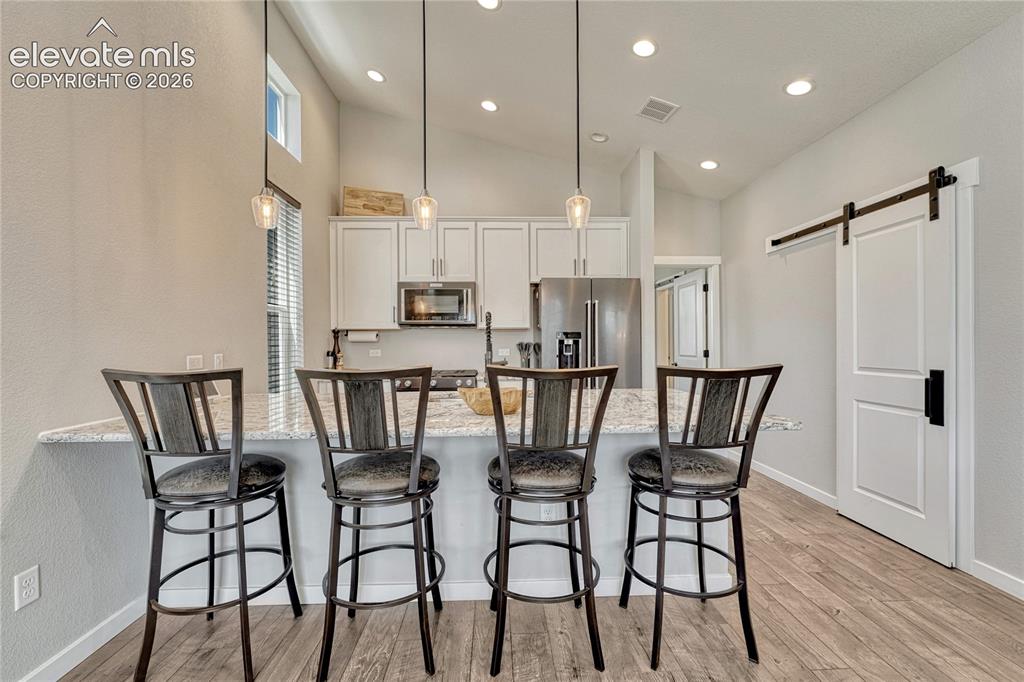Image 11 of 30: Kitchen has luxury vinyl flooring...