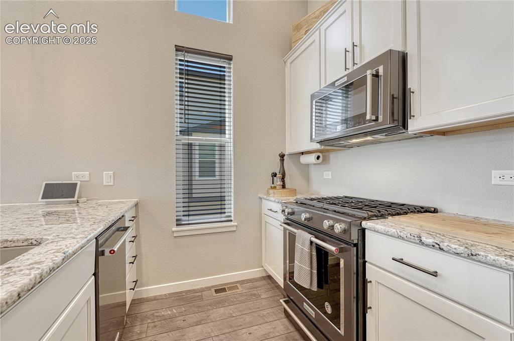 Image 14 of 30: Stainless steel sink and appliances.
