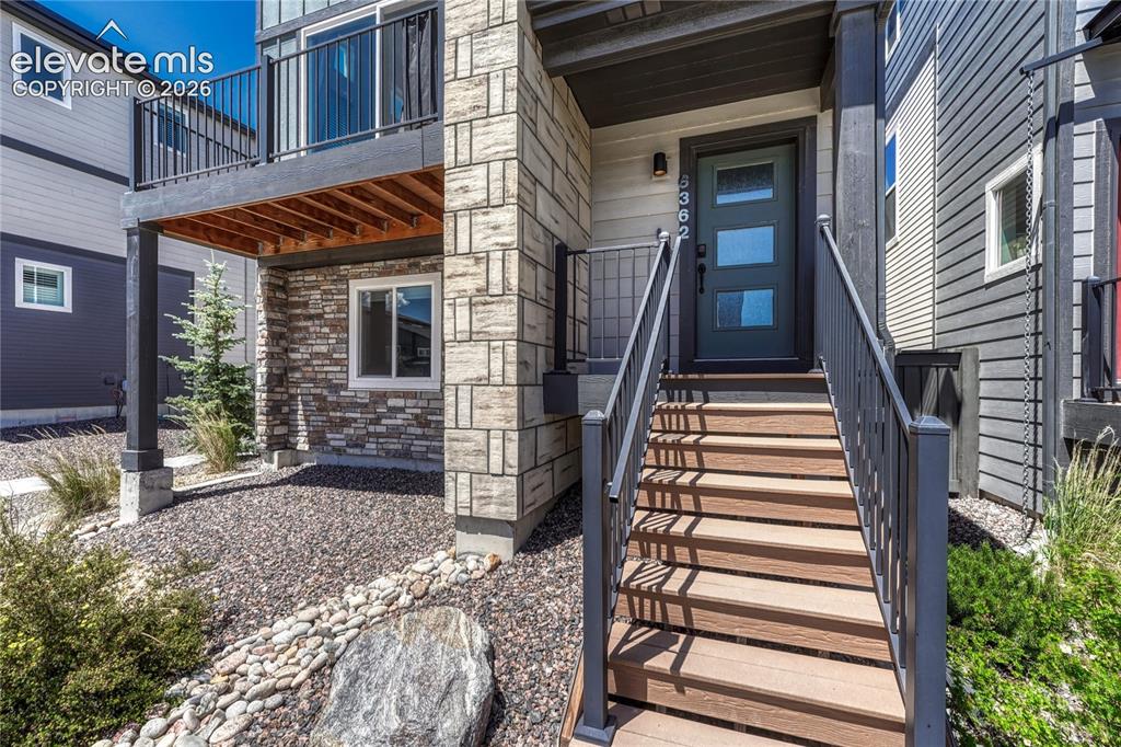 Image 4 of 30: Covered front porch welcomes guests.