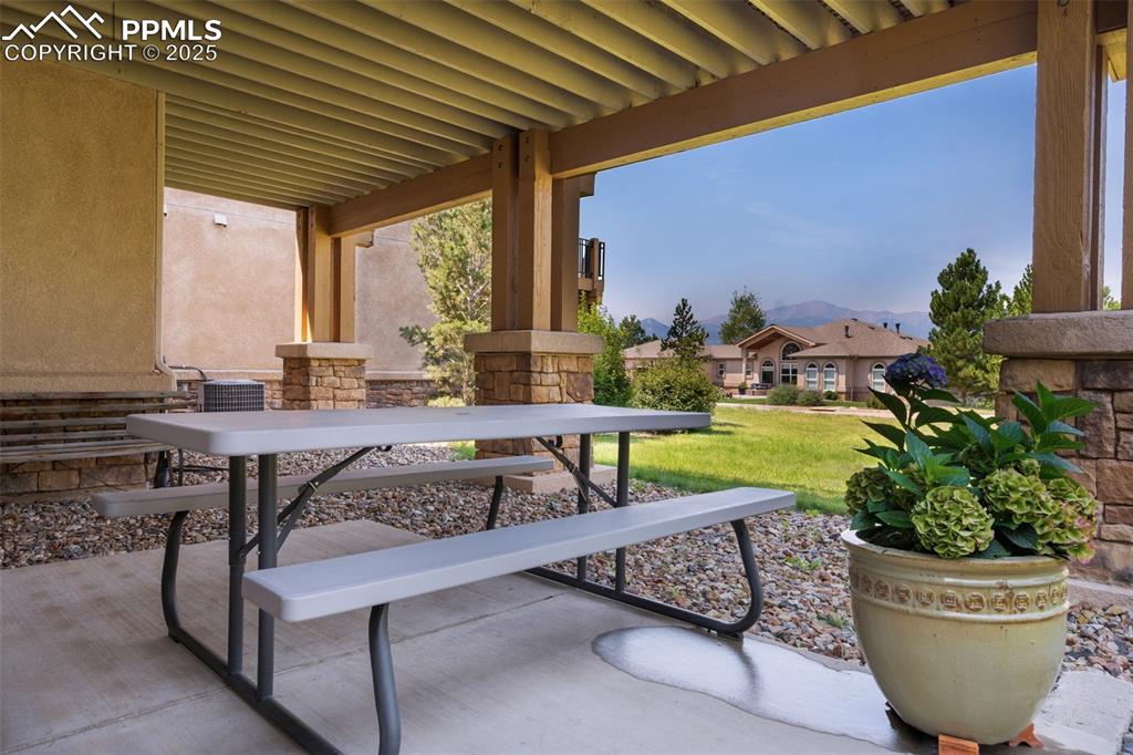 Image 25 of 41: Covered concrete patio with mountain views