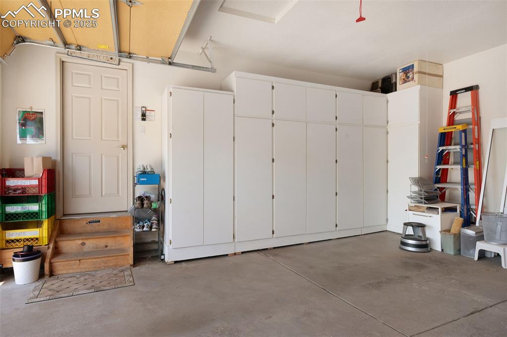 Image 31 of 41: Built-in cabinets in finished 3-car daylight garage