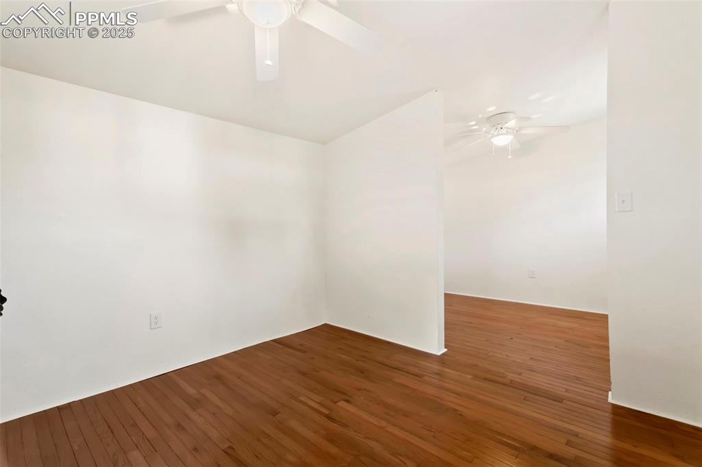 Image 23 of 23: Empty room featuring dark wood finished floors and a ceiling fan