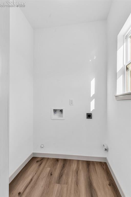 Image 14 of 39: Laundry area featuring hookup for a washing machine, light wood-style floor