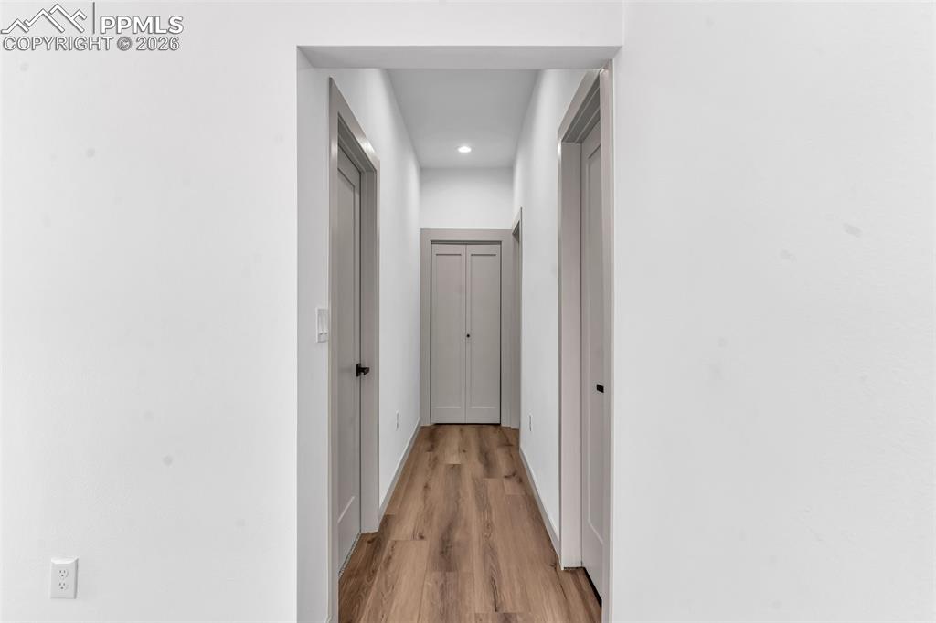 Image 15 of 39: Corridor featuring light wood finished floors and recessed lighting