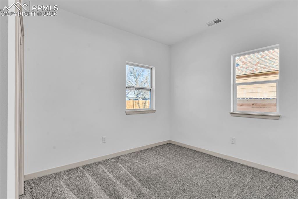 Image 18 of 39: Carpeted empty room featuring baseboards
