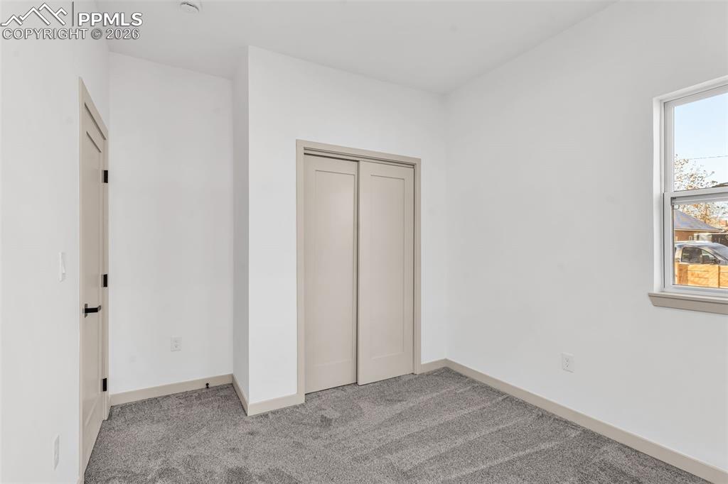 Image 19 of 39: Unfurnished bedroom with light carpet and a closet