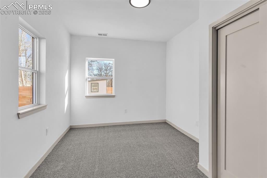 Image 20 of 39: Spare room featuring light carpet and baseboards