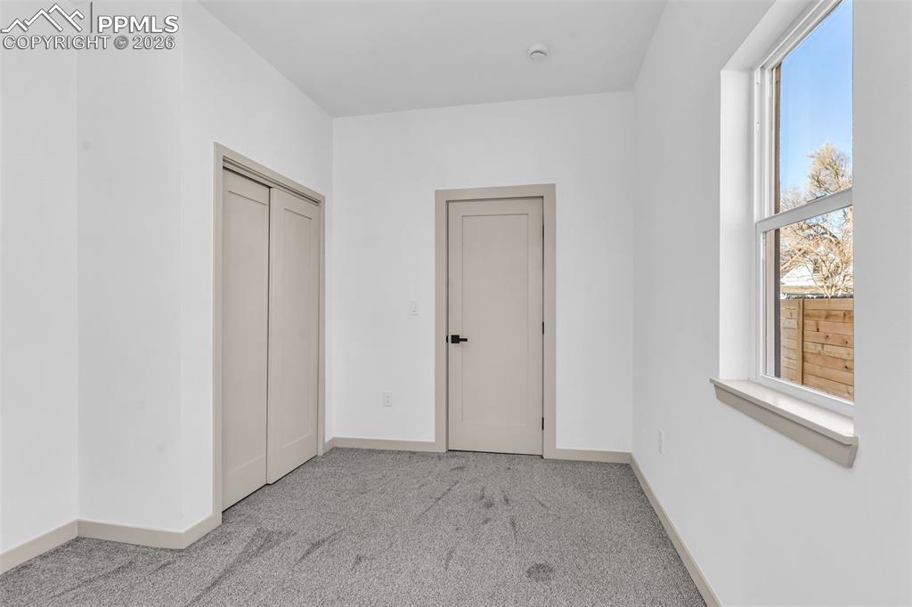 Image 21 of 39: Unfurnished bedroom featuring light colored carpet and a closet