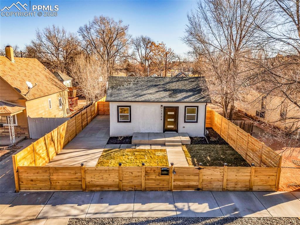Image 29 of 39: View of front of property featuring a fenced front yard, roof with shingles