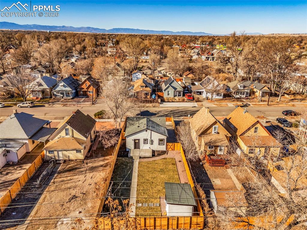 Image 31 of 39: Aerial view of residential area with a mountainous background