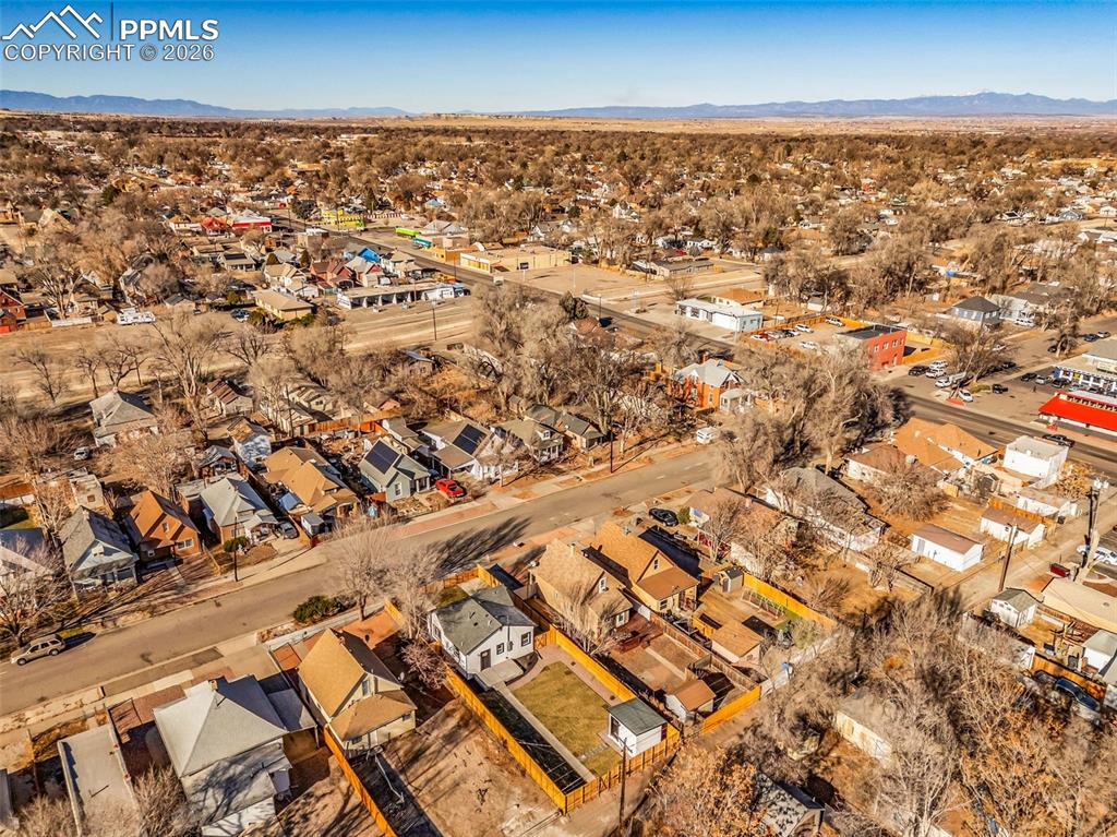 Image 35 of 39: Aerial view of residential area with a mountainous background
