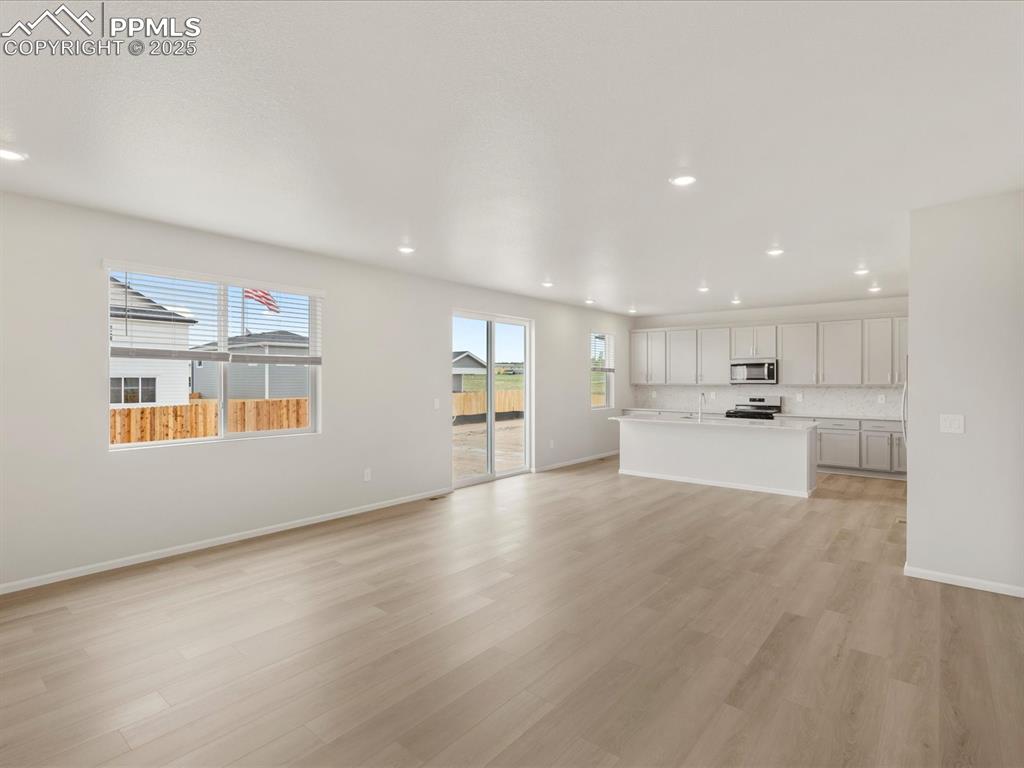 Image 10 of 40: Unfurnished living room featuring recessed lighting, light wood-style floor