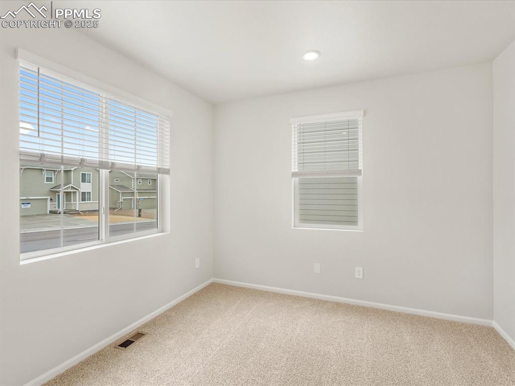 Image 11 of 40: Carpeted spare room with baseboards
