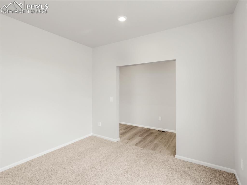 Image 12 of 40: Spare room with light carpet, baseboards, and recessed lighting