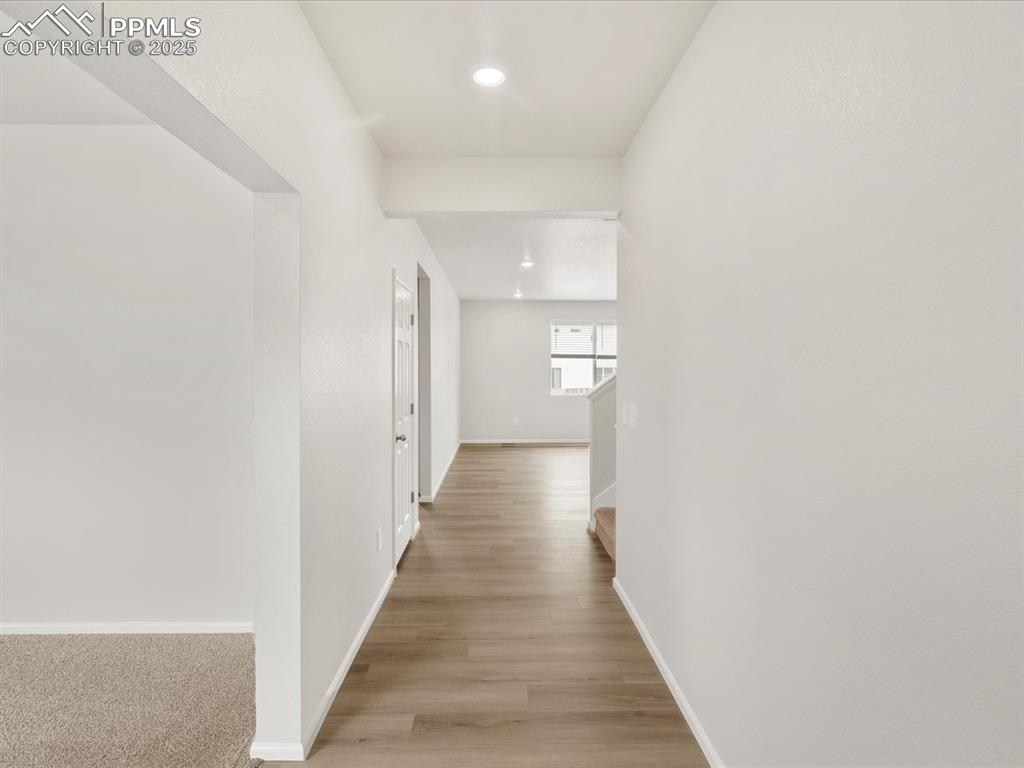 Image 13 of 40: Hallway featuring baseboards, recessed lighting, light wood finished floors