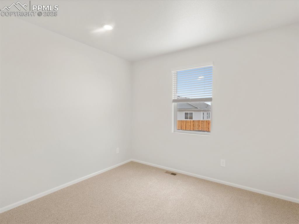 Image 14 of 40: Carpeted spare room featuring baseboards