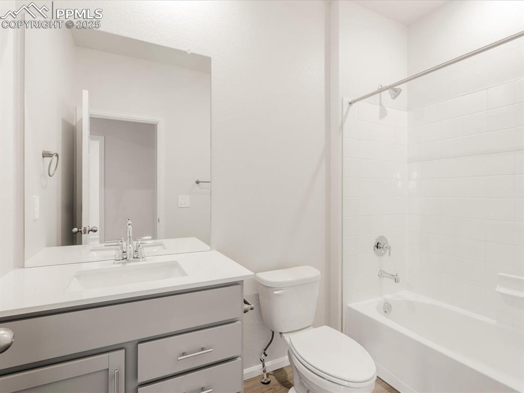 Image 17 of 40: Full bathroom featuring toilet, vanity, bathing tub / shower combination, b