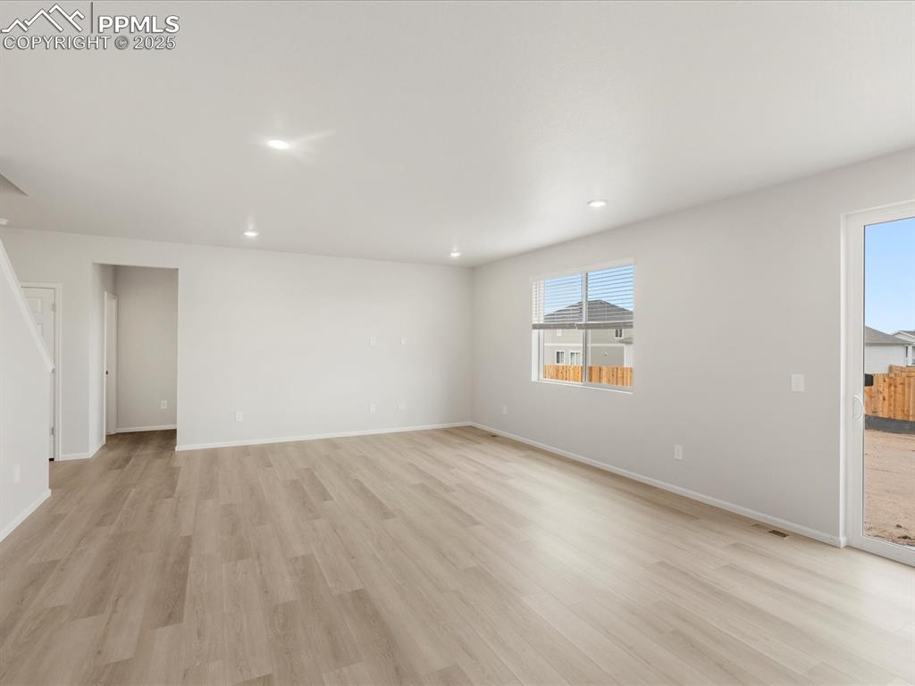 Image 18 of 40: Unfurnished living room featuring light wood-style flooring, recessed light