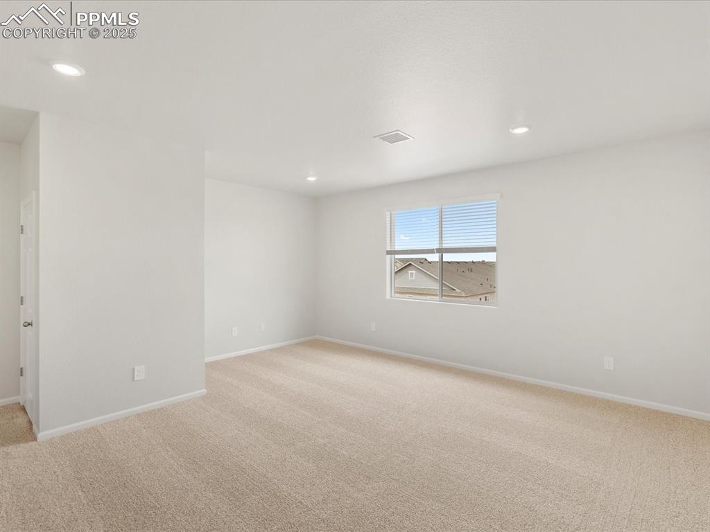 Image 20 of 40: Empty room featuring light colored carpet, baseboards, and recessed lightin