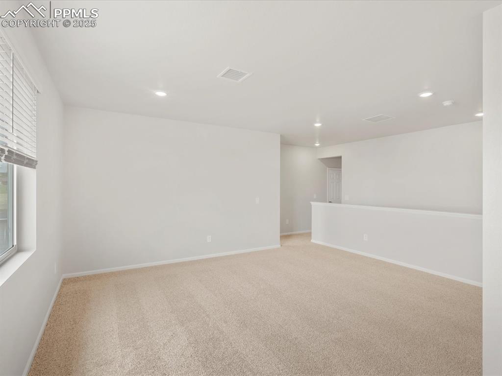 Image 21 of 40: Spare room with recessed lighting, light carpet, and baseboards