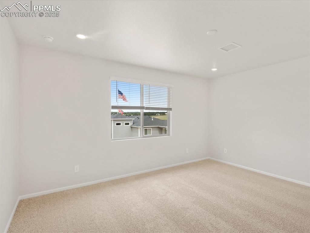 Image 22 of 40: Spare room featuring carpet, baseboards, recessed lighting, and a smoke det