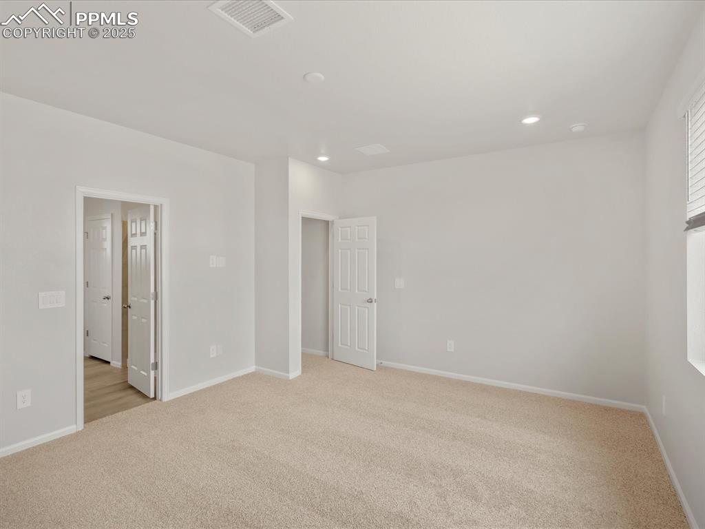 Image 23 of 40: Unfurnished bedroom featuring light carpet, recessed lighting, and baseboar