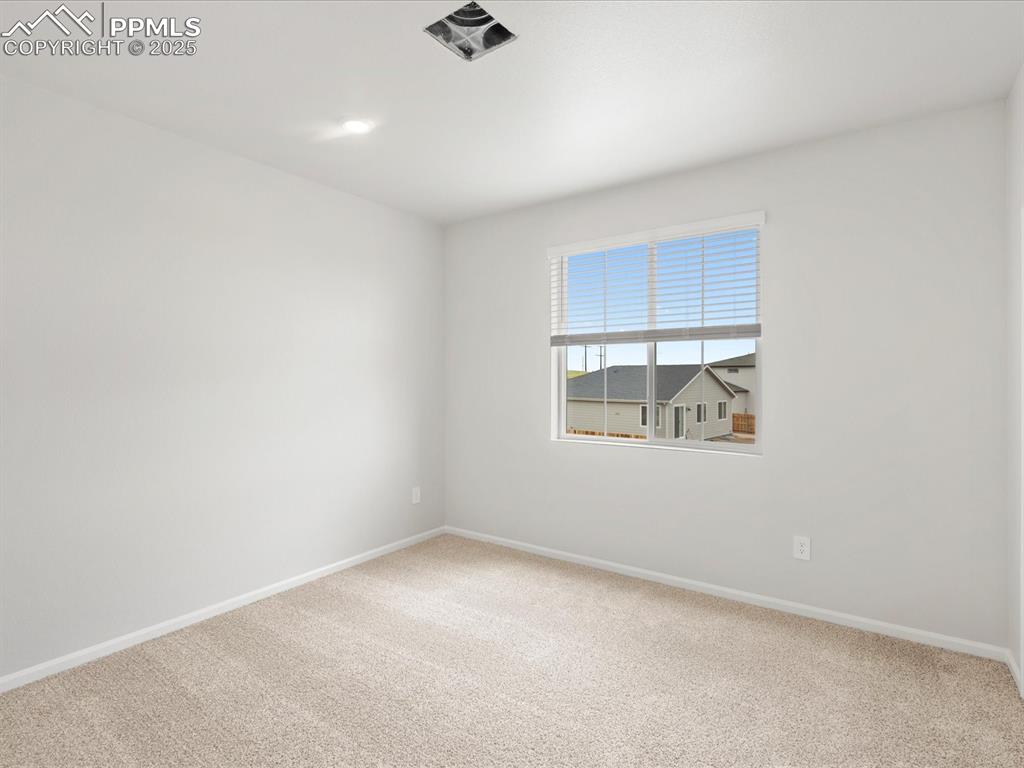 Image 30 of 40: Unfurnished room featuring baseboards and carpet floors