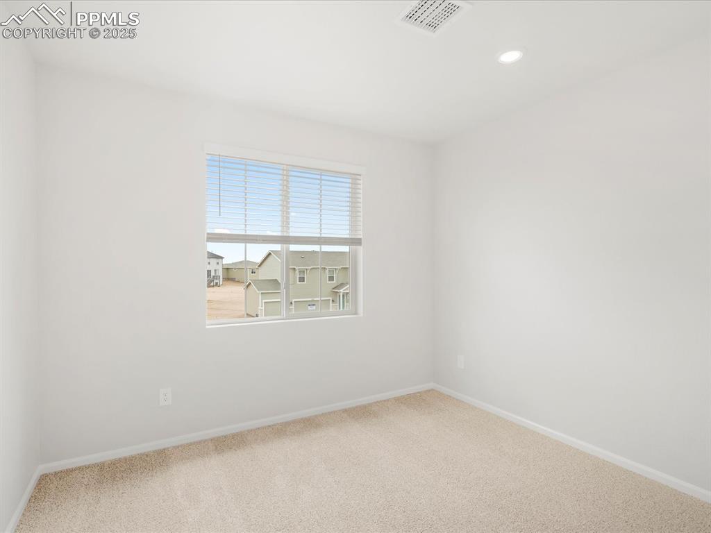 Image 33 of 40: Carpeted spare room with baseboards and recessed lighting