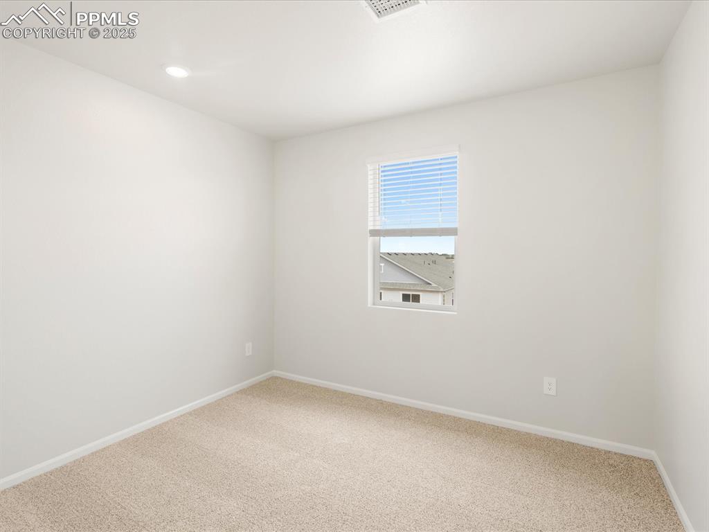 Image 35 of 40: Empty room featuring carpet flooring, baseboards, and recessed lighting