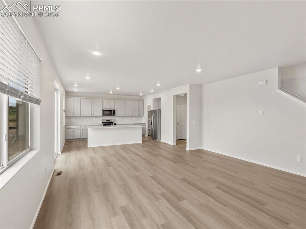 Image 9 of 40: Unfurnished living room featuring recessed lighting, light wood-type floori