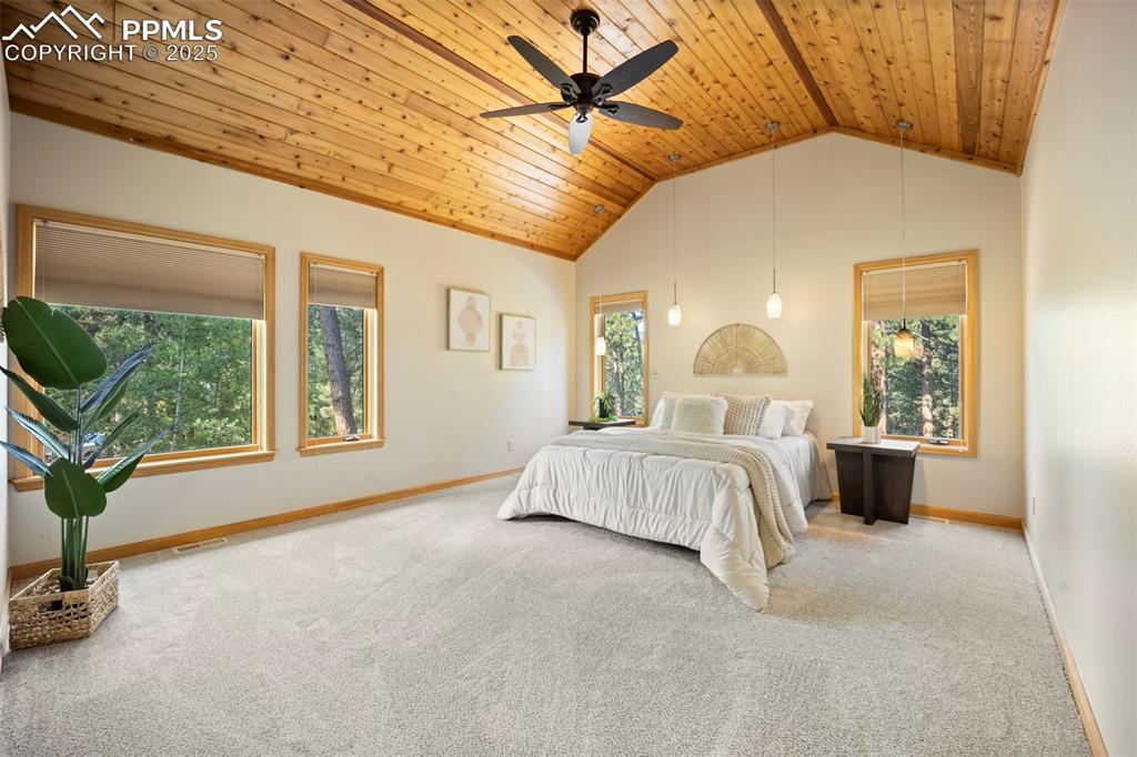 Image 12 of 33: Bedroom with carpet, wooden ceiling, ceiling fan, and high vaulted ceiling